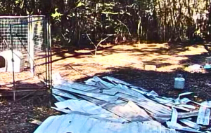 Pile of discarded roofing materials and construction debris left in a residential yard in Slidell, Louisiana, following partial work by Spectrum Roofing and Renovations